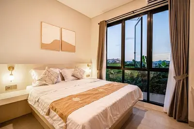 a bedroom with a large bed and a large window at Renjana Villa-2BR Modern Tropical Villa in Seminyak with Private Pool & Rice Field View in Seminyak