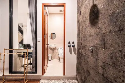 a bathroom with a toilet and a glass doorway at Renjana Villa-2BR Modern Tropical Villa in Seminyak with Private Pool & Rice Field View in Seminyak