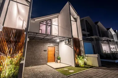 a house with a wooden door on a street at Renjana Villa-2BR Modern Tropical Villa in Seminyak with Private Pool & Rice Field View in Seminyak