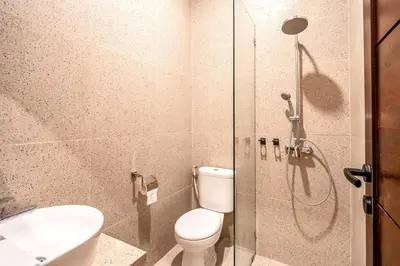 a bathroom with a shower and a toilet and a sink at Renjana Villa-2BR Modern Tropical Villa in Seminyak with Private Pool & Rice Field View in Seminyak