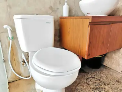 a bathroom with a white toilet and a sink at Large Villa Jimbaran With Pool & WiFi by 2ndHome in Jimbaran