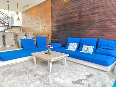 a blue couch and a table in a room at Large Villa Jimbaran With Pool & WiFi by 2ndHome in Jimbaran