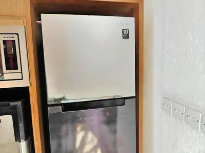 a white refrigerator freezer sitting next to a wall at Large Villa Jimbaran With Pool & WiFi by 2ndHome in Jimbaran