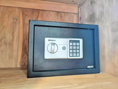 a television with a remote control on a wall at Large Villa Jimbaran With Pool & WiFi by 2ndHome in Jimbaran