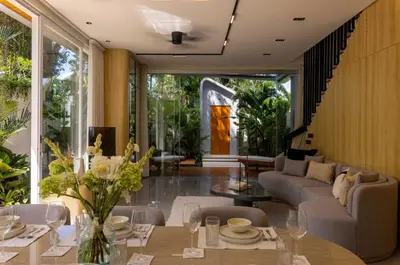 a living room with a couch and a table at Aura Umalas - Futuristic 2BR Rooftop Villa with Green Views in Kerobokan