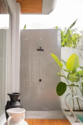 a bathroom with a shower with a plant in it at Aura Umalas - Futuristic 2BR Rooftop Villa with Green Views in Kerobokan