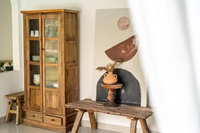 a lamp on a wooden table next to a cabinet at 3BR Green Oasis downtown Berawa Canggu in Canggu