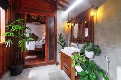 a bathroom with a sink and a mirror and some plants at The Cottage By Selasih in Seminyak