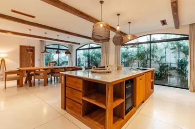 a kitchen with a large island and a dining room at Elegant 4BR Villa downtown Berawa Canggu in Canggu