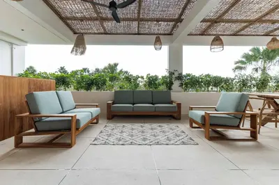 a patio with two chairs and a table at Elegant 4BR Villa downtown Berawa Canggu in Canggu