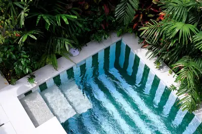an overhead view of a swimming pool with blue water at Martini Beachside Villa 5 in Canggu
