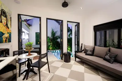 a living room with a couch and a table and chairs at Martini Beachside Villa 5 in Canggu