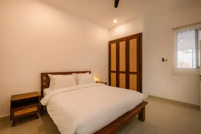 a bedroom with a large white bed and a window at Villa Batu Putih 3 Seminyak in Seminyak