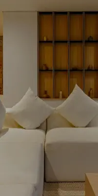 a white couch with pillows sitting in a room at Cocon Maison Timal in Kerobokan