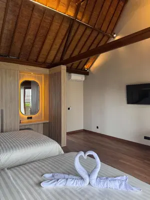two white swans sitting on a bed in a bedroom at Family Haven 6BR Luxe Villa in Berawa, Canggu in Canggu