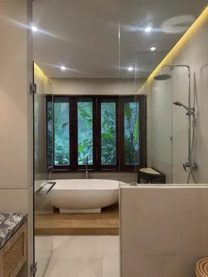 a bathroom with a bath tub and a window at Family Haven 6BR Luxe Villa in Berawa, Canggu in Canggu