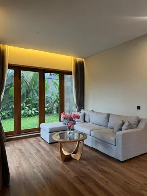 a living room with a couch and a table at Family Haven 6BR Luxe Villa in Berawa, Canggu in Canggu