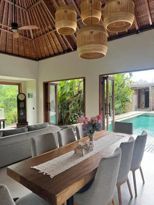 a dining room with a table and chairs and a pool at Family Haven 6BR Luxe Villa in Berawa, Canggu in Canggu