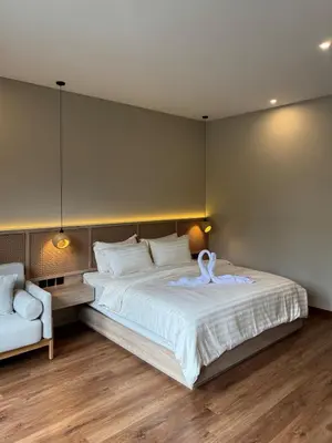 a bedroom with a large bed with a swan on it at Family Haven 6BR Luxe Villa in Berawa, Canggu in Canggu