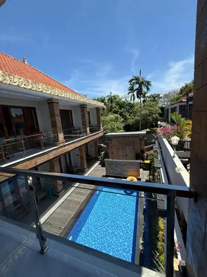 a swimming pool on the balcony of a house at Mara inn in Nusa Dua