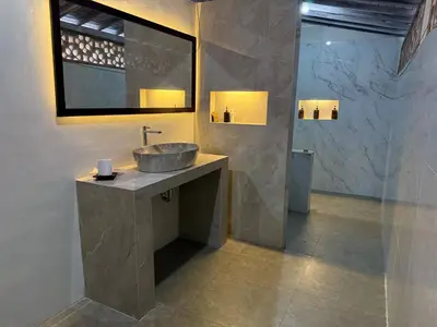 a bathroom with a sink and a mirror at Mara inn in Nusa Dua