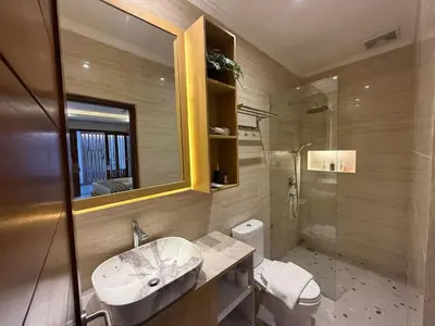 a bathroom with a sink and a shower and a toilet at Mara inn in Nusa Dua