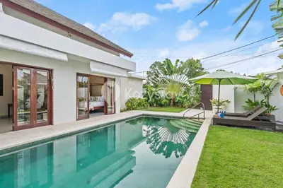 a villa with a swimming pool and a house at Andrew Villa by Kozystay - Umalas in Canggu