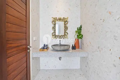 a bathroom with a sink and a mirror at Andrew Villa by Kozystay - Umalas in Canggu