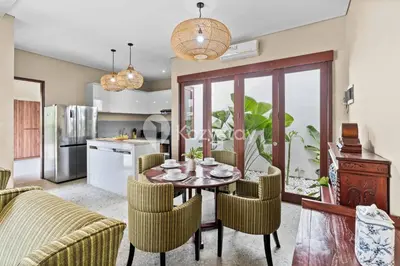 a kitchen and dining room with a table and chairs at Andrew Villa by Kozystay - Umalas in Canggu