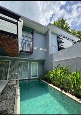 a house with a swimming pool in front of it at 2 bedroom with pool tropical in Nusa Dua