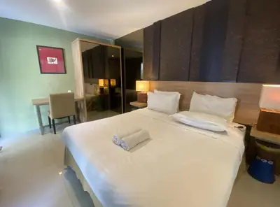 a bedroom with a large white bed with two pillows at 2 bedroom with pool tropical in Nusa Dua