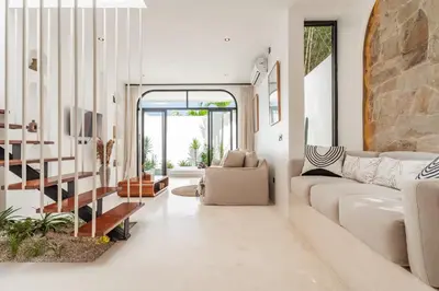 a living room with a couch and a table at Casa Nalani in Bali in Kerobokan