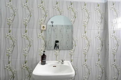 a bathroom with a sink and a mirror at Kamar Kodel2 Apt in Seminyak