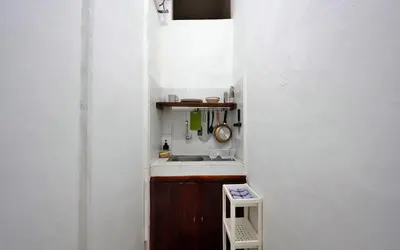 a small kitchen with a sink and a counter at Kamar Kodel1 in Seminyak