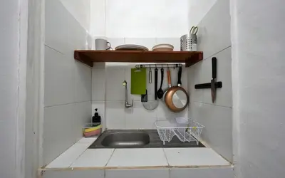 a kitchen with a sink in a small room at Kamar Kodel1 in Seminyak