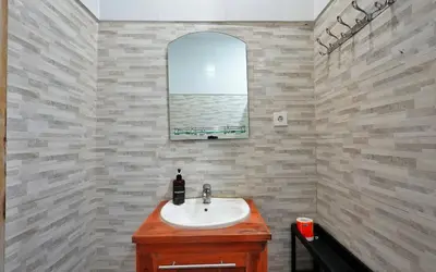 a bathroom with a sink and a window at Kamar Kodel1 in Seminyak