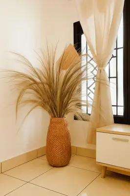 a vase with a plant in a room at Villa Cempaka - Pemogan in Denpasar