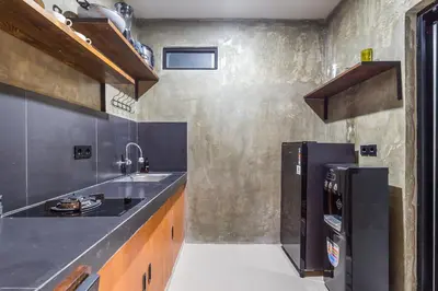 a kitchen with a sink and a refrigerator at ChinGiack Apartments Canggu Pool and Terrace in Canggu