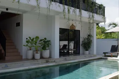 a villa with a swimming pool and a house at ChinGiack Apartments Canggu Pool and Terrace in Canggu