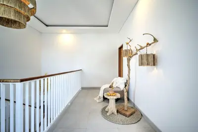 a white hallway with a bench in a room at Villa Esha I in Seminyak