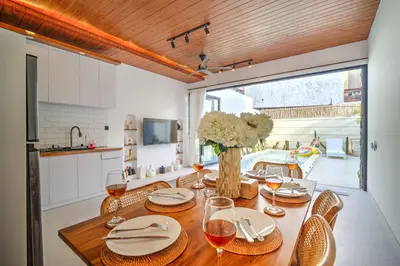 a dining room with a table with wine glasses at Villa Esha I in Seminyak