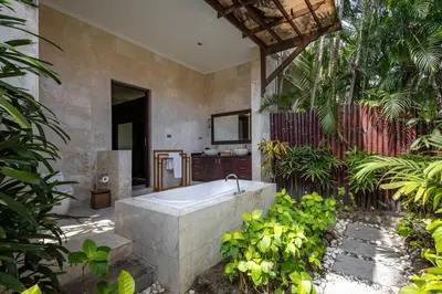 a bathroom with a bath tub in a garden at 5 Bedroom Luxury Villa With Huge Garden & Pool 150-Metres To Seminyak Beach in Seminyak