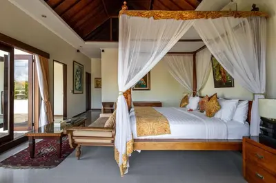 a bedroom with a canopy bed and a desk at 5 Bedroom Luxury Villa With Huge Garden & Pool 150-Metres To Seminyak Beach in Seminyak