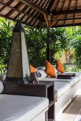 a lantern sitting on top of a table with pillows at 5 Bedroom Luxury Villa With Huge Garden & Pool 150-Metres To Seminyak Beach in Seminyak