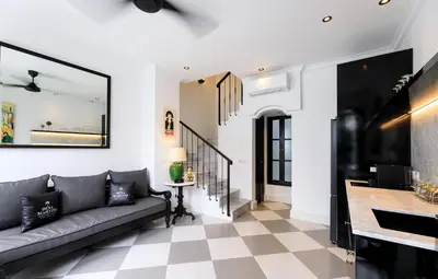 a living room with a couch and a checkered floor at Martini Beachside Villa 7 in Canggu