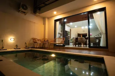 a house with a swimming pool and a dining room at Modern tropical House Villa in Seminyak