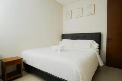 a bedroom with a large bed with white sheets and pillows at Modern tropical House Villa in Seminyak