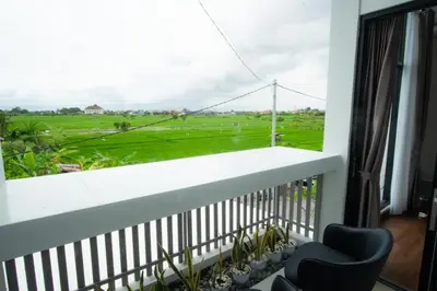 a balcony with a view of a green field at Modern tropical House Villa in Seminyak