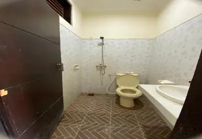 a bathroom with a toilet and a sink at Hotel Near Beach Ayu inn Kuta in Kuta