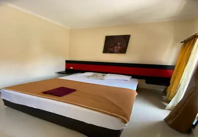 a bedroom with a bed in a room at Hotel Near Beach Ayu inn Kuta in Kuta